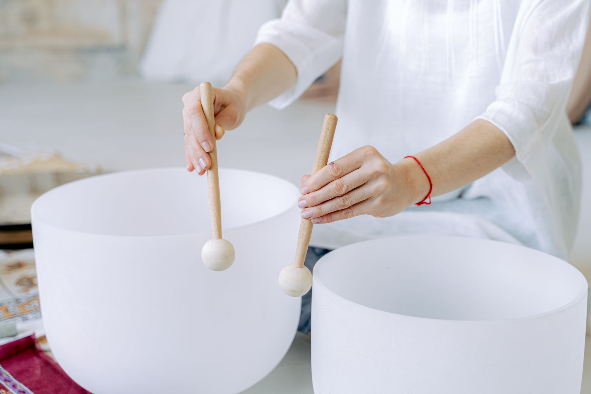 Crystal singing bowls glowing in soft light for a sound healing session